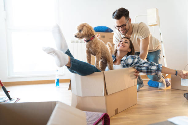 Young playful couple at their new apartment 