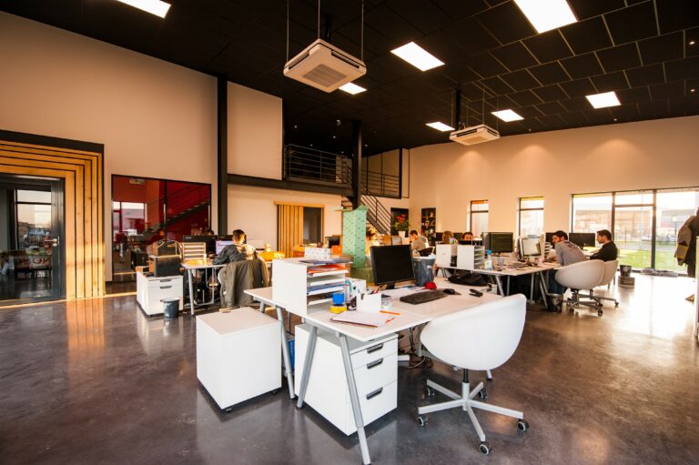 A professional-looking office with desks, chairs, and computers.